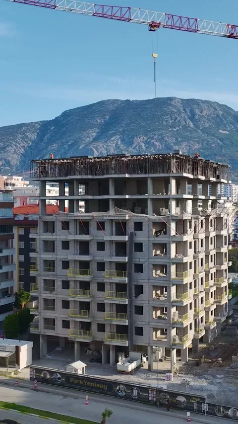 Vertical Video Top Down View of Workers Positioned Across Building Frame Stock Footage 342116000