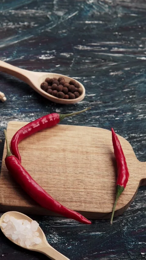 Vertical video top down view of fresh red chili peppers and spices on wooden Stock Footage 345212419