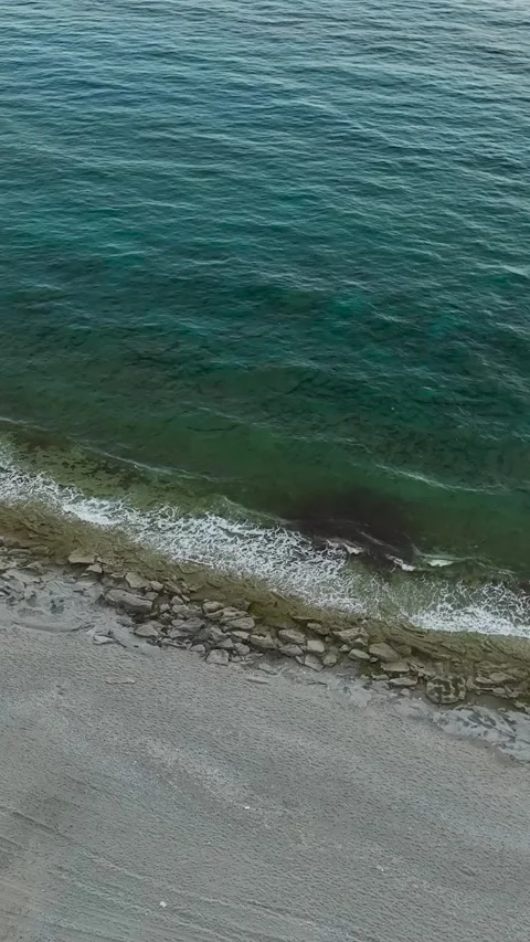 Vertical Video Top View Coastal Texture with Waves Breaking Over Stone Stock Footage 341779085