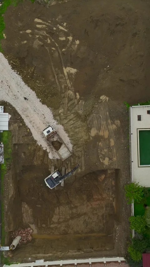 Vertical Video Top View Construction Site Layout with Machinery and Soil Tracks Stock Footage 342429343