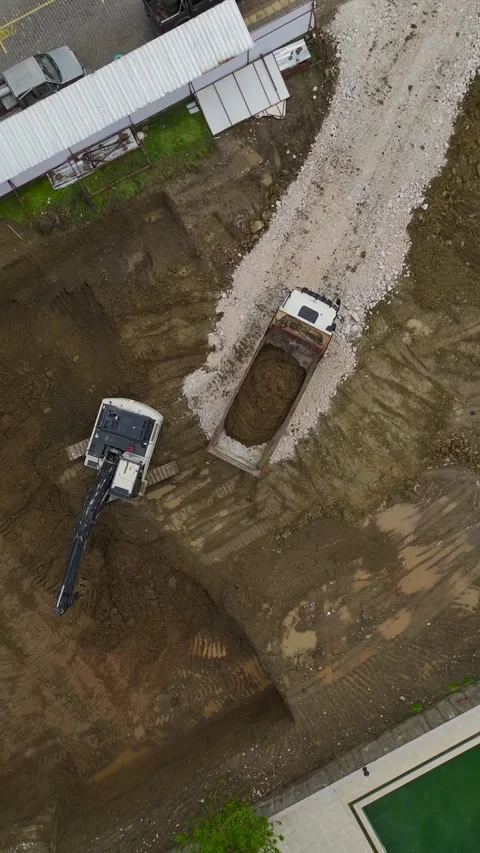 Vertical Video Top View Construction Site with Soil Movement and Machinery Stock Footage 342430411