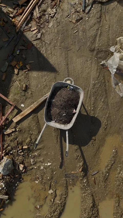 Vertical Video Top View Construction Wheelbarrow with Dirt and Tools Stock Footage 342443184