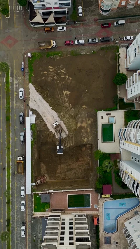 Vertical Video Top View Excavator Bucket Dropping Soil into Dump Truck Stock Footage 342429009