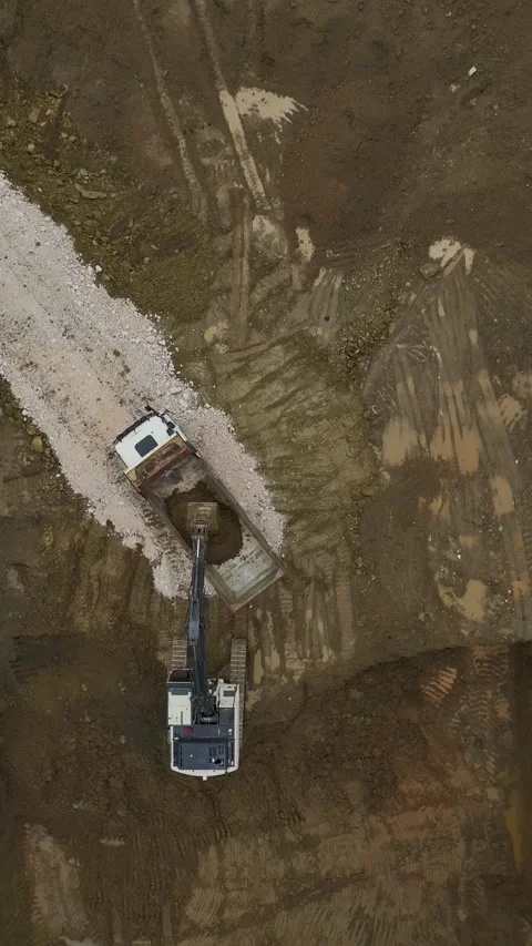 Vertical Video Top View Excavator Digging Soil in Urban Construction Area Stock Footage 342429596