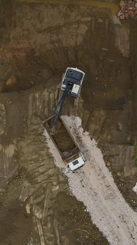 Vertical Video Top View Excavator and Truck Working on Foundation Excavation Stock Footage 342430817
