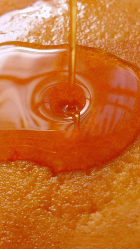 Vertical Video Top View of Maple Syrup being Poured on Top of Stack of Stock Footage 340839165