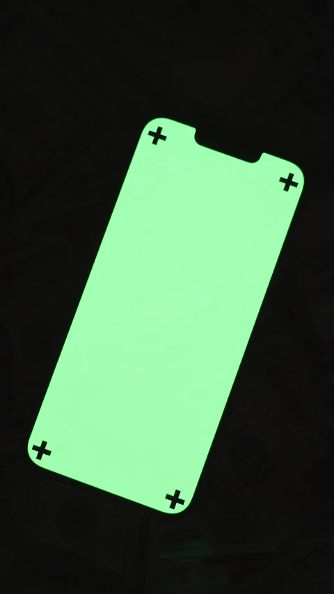 Vertical video. Top-View Shot of a Smartphone with a Bright Green Screen and Stock Footage 296364849