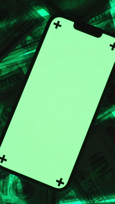 Vertical video. Top-View Shot of a Smartphone with a Bright Green Screen and Stock Footage 296381011