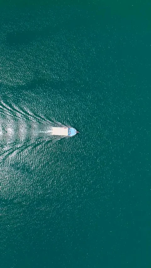 Vertical Video Top View Single Boat in Open Water Creating V Shape Wake Pattern Stock Footage 342195341