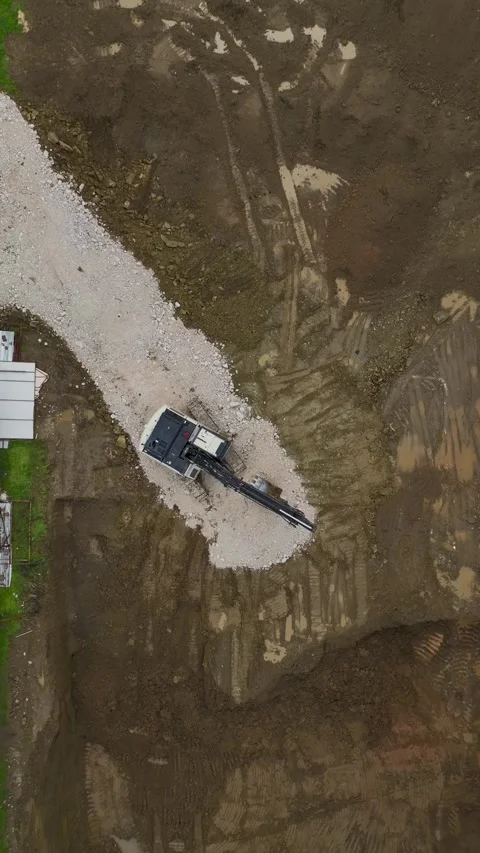 Vertical Video Top View Urban Construction Site with Excavation and Transport Stock Footage 342426173