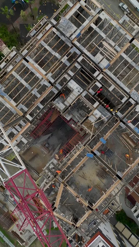 Vertical Video of Tower Crane Assisting High-Rise Wall Construction Stock Footage 342423526