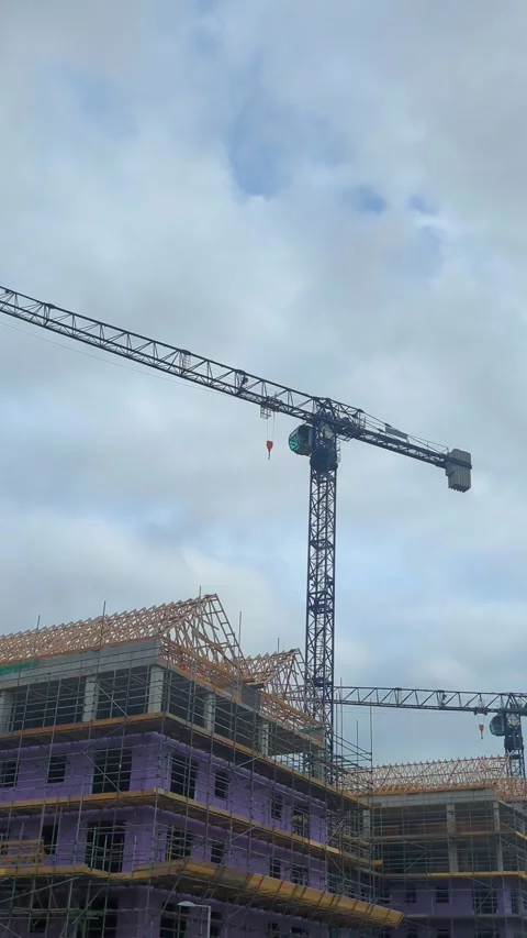 Vertical Video of Tower Crane Constructing New Apartment Buildings with Stock Footage 333682234