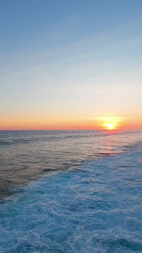 Vertical video. Tracking A Glassy Sunset Wave at Nyang Nyang Beach, Vibrant Even Video stock 336642740