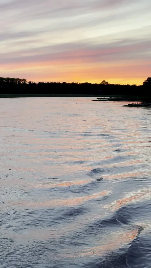 Vertical video tracking shot shows pretty sunset over river Stock Footage 341526431