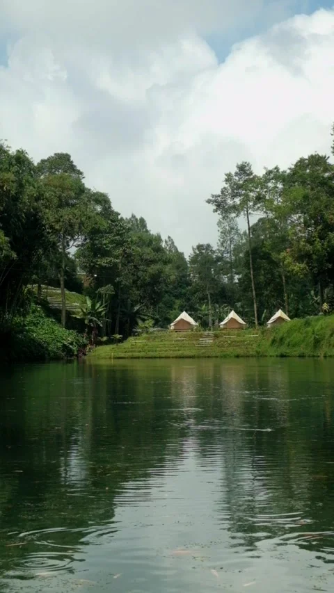 Vertical video of a tranquil lake view with a camping area Stock Footage 320055520