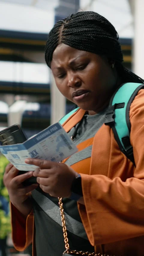 Vertical video Traveler studies bus ticket using smartphone to confirm planned Stock Footage 340206111