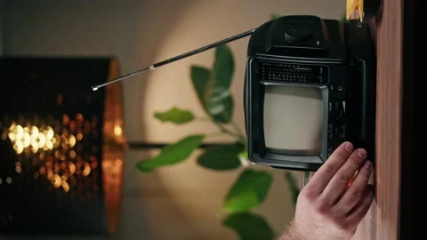 Vertical video of turning on small old television with grey interference screen Stock Footage 182004404