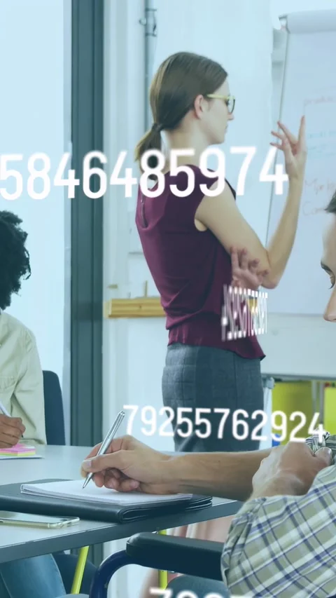 Vertical video: Tutor gesturing, writing on chart showing class data, codes Stock Footage 335355618