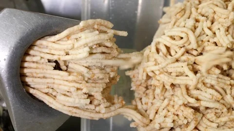 Vertical video. Twisted bread with a roll in a meat grinder falls into a plastic Video stock 248906465