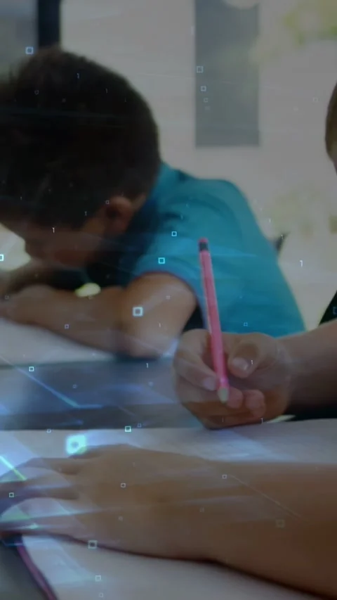 Vertical video: Two boys writing cam pan as pink pencil entering frame blue Stock Footage 333840329