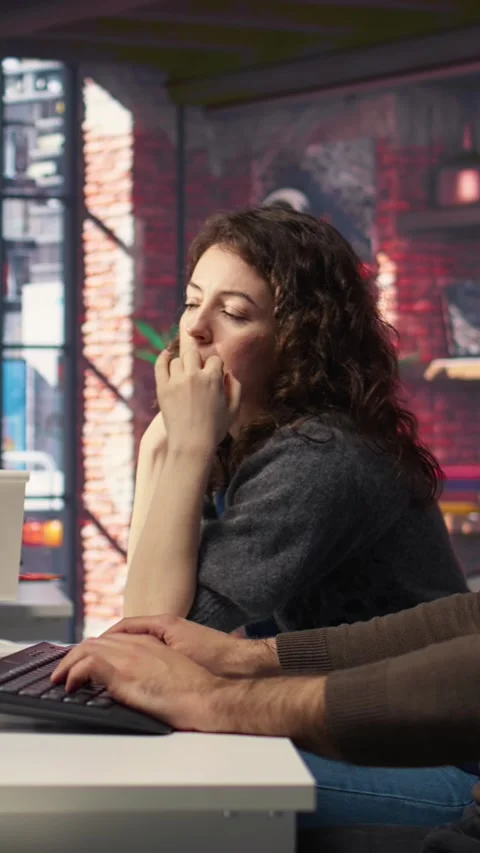 Vertical Video Two developers team interact with virtual AI assistant on PC Stock Footage 308493386