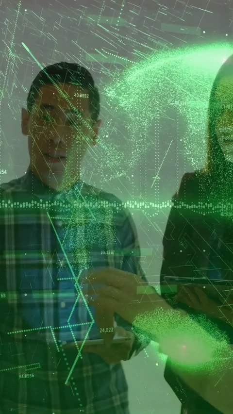 Vertical video: Two devs tapping phones gesturing at wall globe reacting to Stock Footage 332644590