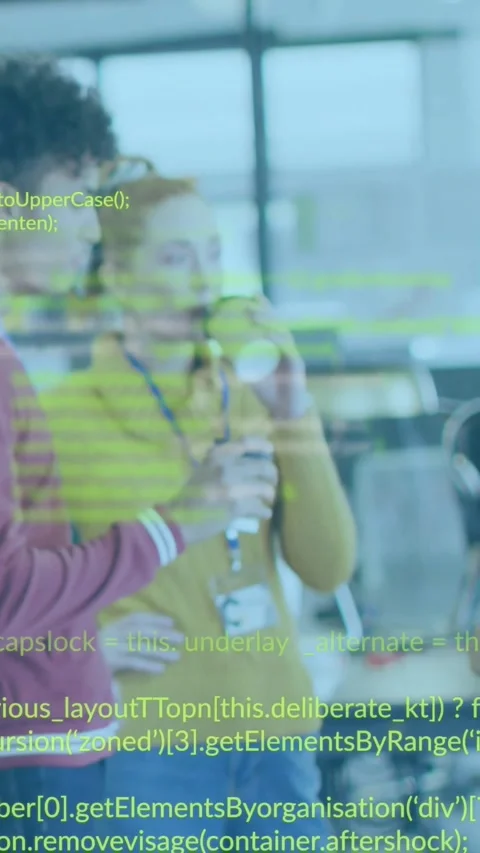 Vertical video: Two devs viewing screen update for debugging, code overlaying Stock Footage 330769841