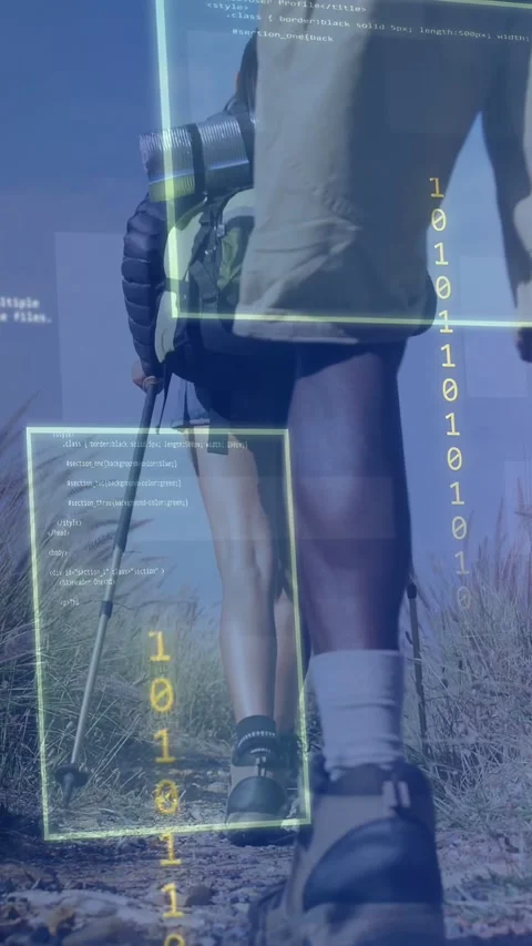 Vertical video: Two hikers hiking dunes, steps causing HUD framing boots, pole, Stock Footage 333487308