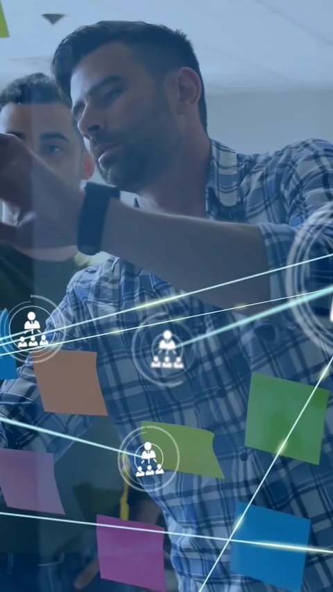 Vertical video: Two men drawing on glass wall, marker causing overlay nodes to Stock Footage 330286394