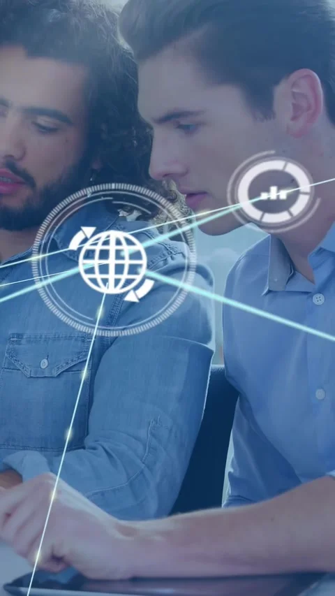 Vertical video: Two men leaning over desk, tapping tablet, starting network HUD Stock Footage 331178044