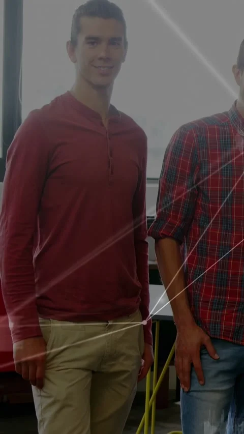 Vertical video: Two men posing, camera rising showing face, node grid passing 스톡 동영상 333222105