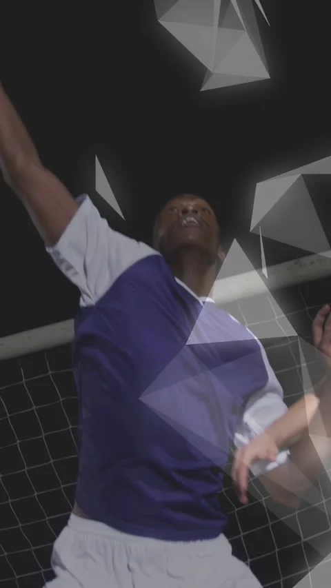 Vertical video: Two men spotting soccer ball, leaping defending goal, triangles Stock Footage 333862344