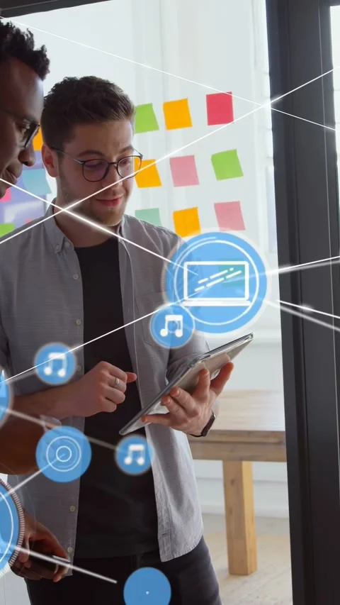 Vertical video: Two men tapping tablet by notes, initiating AR blue icons 库存影片 333006258