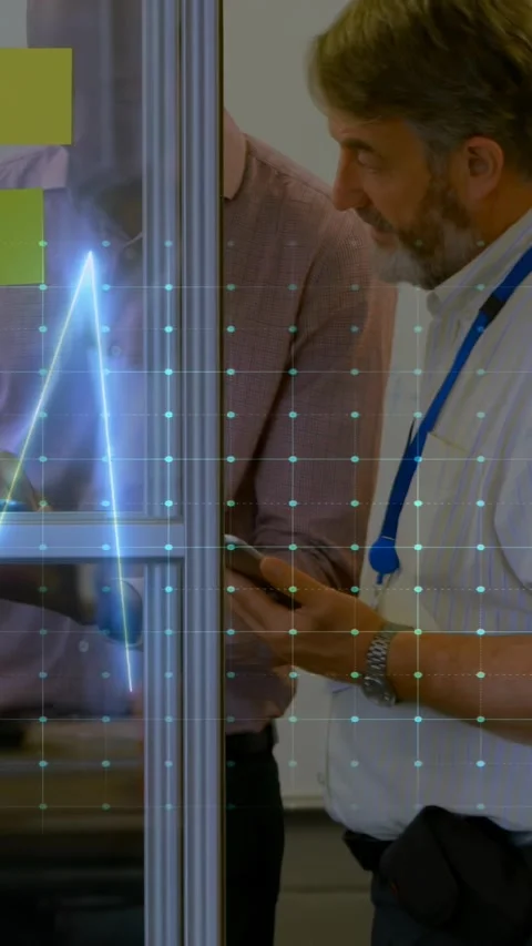 Vertical video: Two men tapping devices and comparing screens for business, ECG Stock Footage 334319071