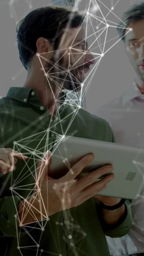 Vertical video: Two men tapping tablet pointing causing tech mesh crossing faces Stock Footage 334694980
