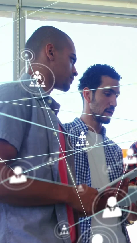 Vertical video: Two men using tablet by blinds, tapping and causing growing Stock Footage 333020747