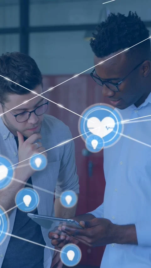 Vertical video: Two men using tablet right man tapping causing heart icon Stock Footage 333464924