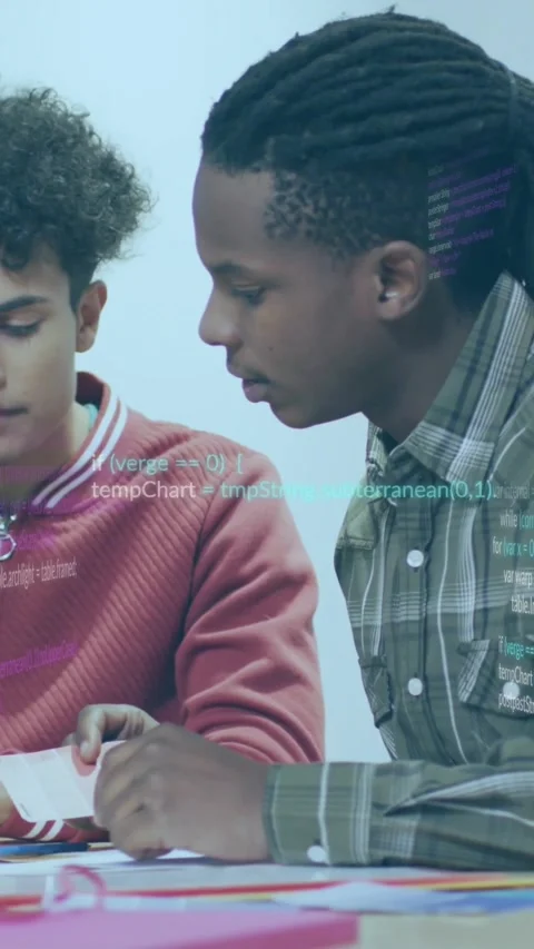 Vertical video: Two peers flipping pages, pointing, causing code overlay during Stock Footage 330242444