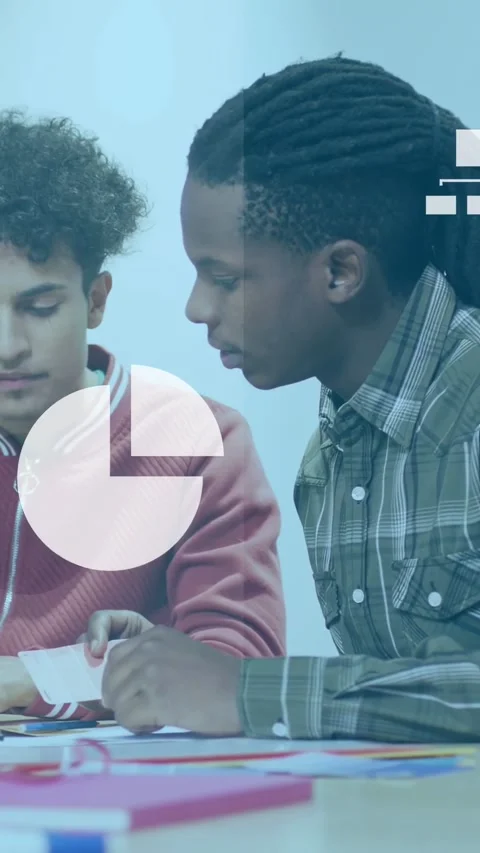 Vertical video: Two peers reviewing learning data at table, cloud icon popping, Stock Footage 333556512