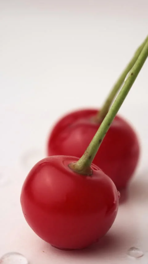 Vertical video of two red ripe cherries covered with drops water Stock Footage 280248817