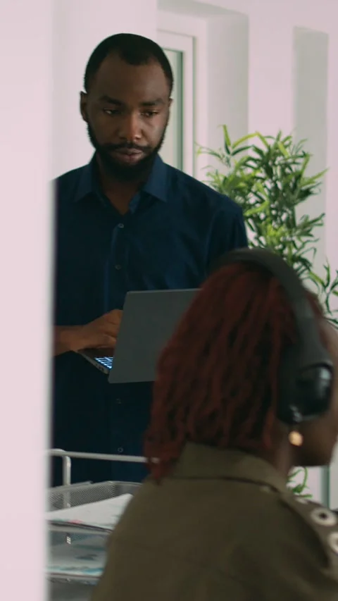 Vertical video: Two software coders analyzing source code looking for errors on Stock Footage 218576978