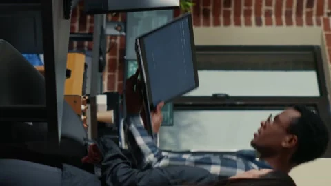 Vertical video Two software developers holding laptop with coding interface Stock Footage 194144958