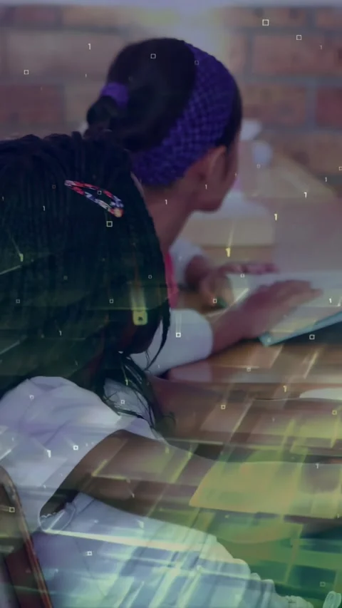 Vertical video: Two students sitting in classroom, reading notebooks as digital Stock Footage 331274118