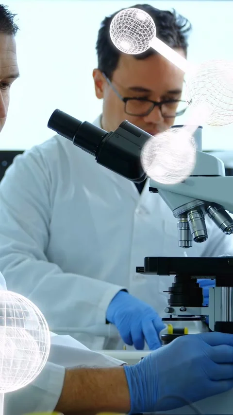 Vertical video: Two techs at scope partner pipette drawing on slide, molecule Stock Footage 335264064