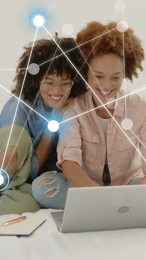 Vertical video: Two women placing laptop, notes, showing network nodes over Stock Footage 337540733