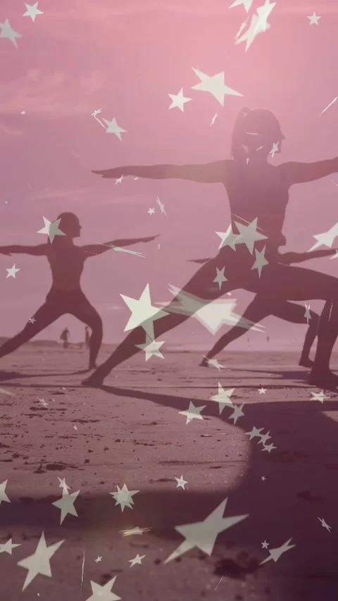 Vertical video: Two women practicing yoga at beach low sun making star overlay Stock Footage 333913124