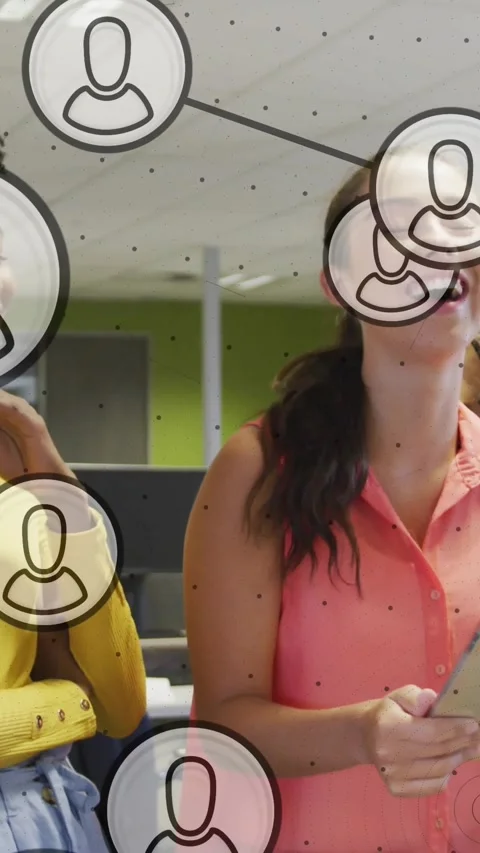 Vertical video: Two women tapping tablet, causing floating icons to drift and Stock Footage 330429958