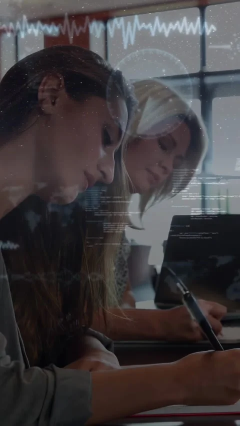 Vertical video: Two women writing notes at table as waveform overlay fading in Vídeos de archivo 330359363