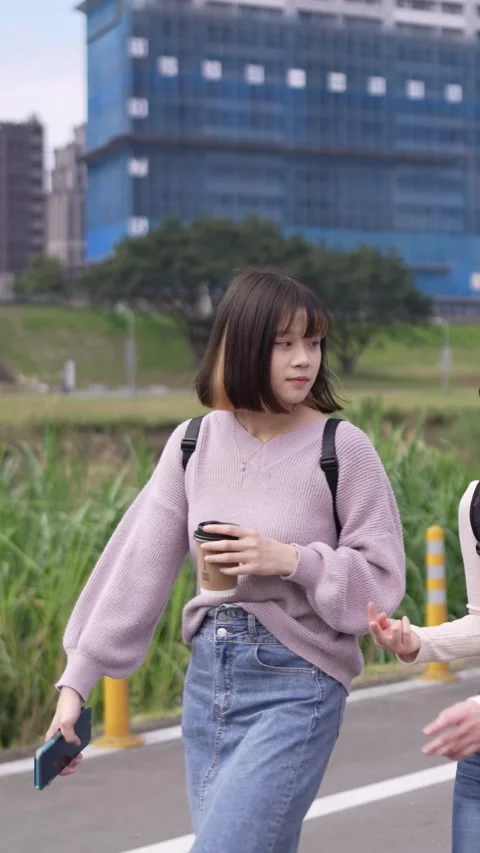 A vertical video of two young Taiwanese female college students Stock Footage 266381811