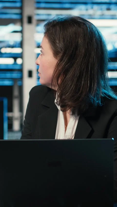 Vertical video Typing on keyboard, laptop and engineer in data center Stock Footage 329316471